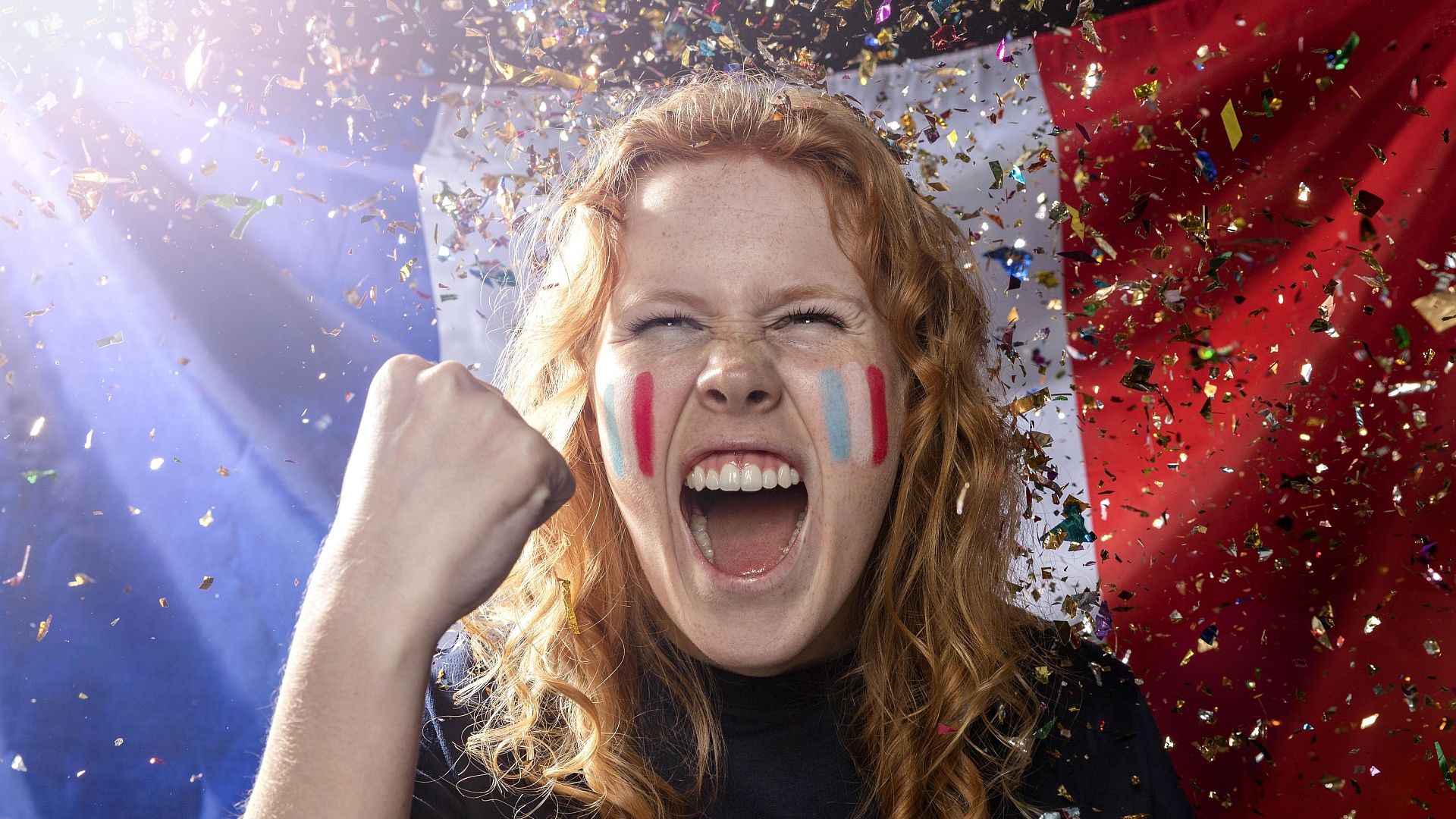 Paris Olympics 2024:  Cheering woman with French flags on the cheeks