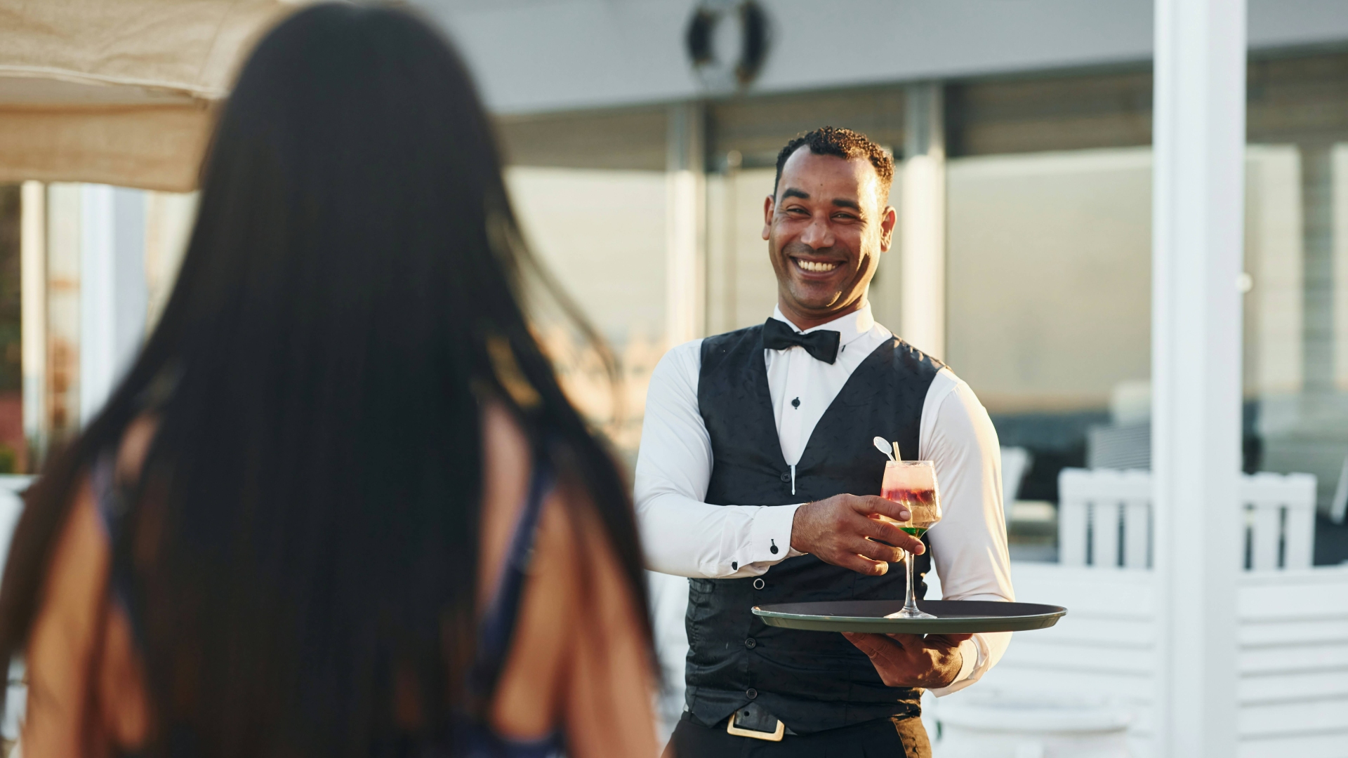 Waiter serving drink